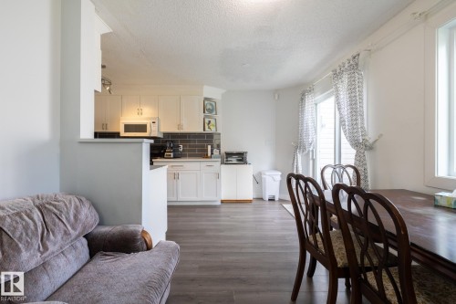 Open-concept layout featuring wood-finish flooring - #43 1033 Youville Dr W Nw, Edmonton, AB - Indoor Photo Showing Other Room