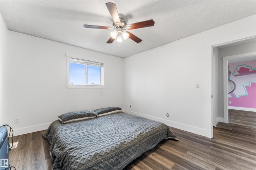 Bedroom featuring wood-finish flooring, white walls, and a window for natural light - 35 Oakridge Dr, St. Albert, AB - Indoor Photo Showing Bedroom