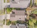 Asphalt shingle roofing, paved driveway, mature trees, and a rear wood deck - 35 Oakridge Dr, St. Albert, AB  - Outdoor With Deck Patio Veranda 
