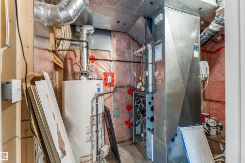 Mechanical room featuring a water heater, furnace, and extensive ductwork - 35 Oakridge Dr, St. Albert, AB - Indoor Photo Showing Basement