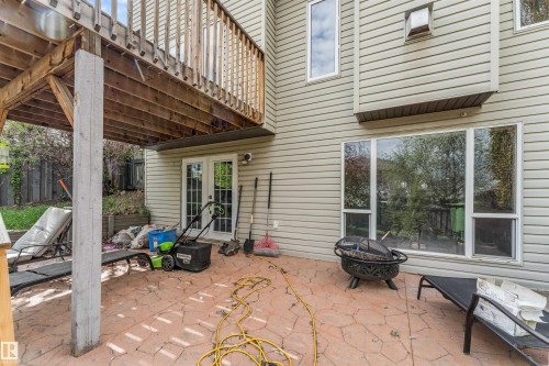 Rear patio featuring stamped concrete, wood deck overhead, and light-colored siding - 35 Oakridge Dr, St. Albert, AB - Outdoor With Deck Patio Veranda With Exterior