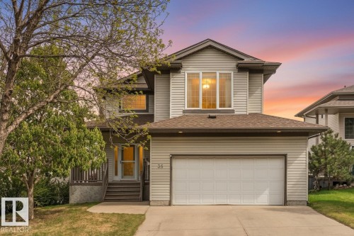 Traditional-style residence featuring light-toned siding, a multi-pane front window, and a prominent attached garage - 35 Oakridge Dr, St. Albert, AB - Outdoor