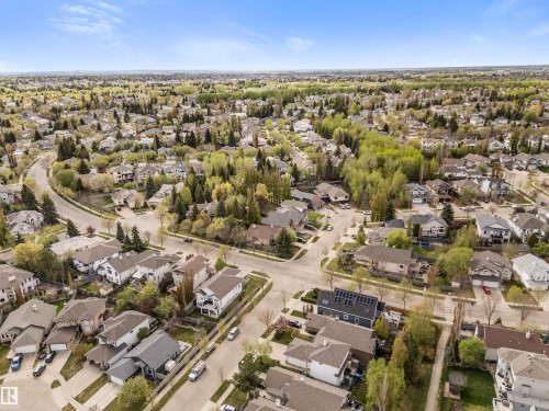 Aerial perspective showcasing a residential neighborhood with mature trees and a curvilinear street layout - 35 Oakridge Dr, St. Albert, AB - Outdoor With View