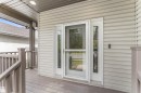Covered porch with wood-finish decking and railing - 35 Oakridge Dr, St. Albert, AB  - Outdoor With Deck Patio Veranda With Exterior 