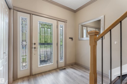 Entryway featuring a front door with decorative glass inserts, flanked by matching sidelights - 35 Oakridge Dr, St. Albert, AB - Indoor Photo Showing Other Room