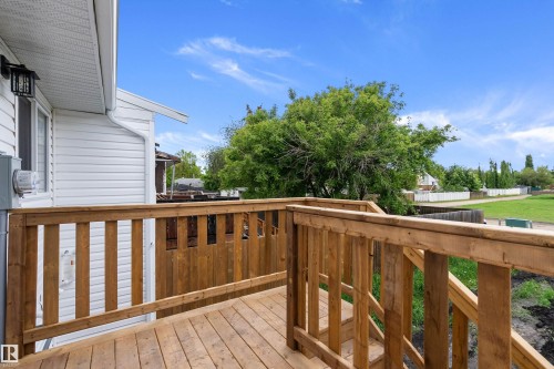Wood deck with natural finish, featuring a full railing system - 5210 55 Avenue, Wetaskiwin, AB 