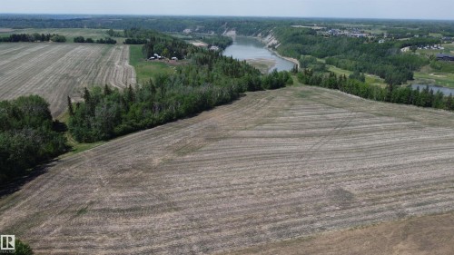 Expansive cleared land featuring a natural tree line and  river frontage - 6015 200 Street, Edmonton, AB 