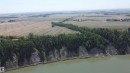 Expansive raw land featuring mature trees, a riverfront, and agricultural fields - 6015 200 Street, Edmonton, AB 