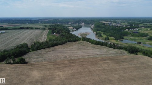 Expansive land parcel featuring cleared fields, mature tree lines and river views. - 6015 200 Street, Edmonton, AB 