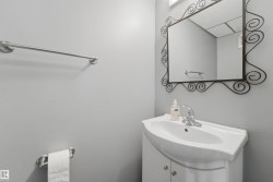 Compact bathroom vanity with integrated white basin, chrome faucet, and a decorative framed mirror - 