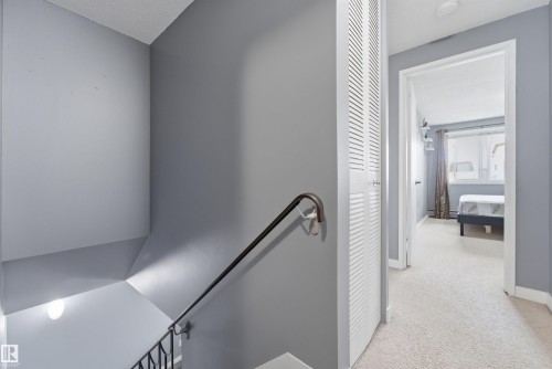 Upper-level hallway featuring light gray walls and plush carpeting - #110 7805 159 St Nw, Edmonton, AB 