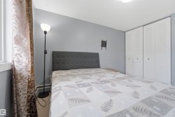 Bedroom featuring light grey walls, carpet flooring, and a window with white trim - 