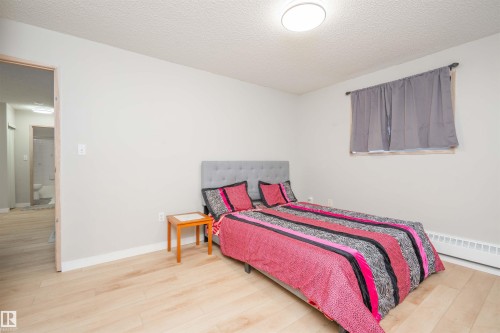 Bright room with light wood-finish flooring and a flat-panel ceiling light fixture - 108 2508 50 Street, Edmonton, AB 