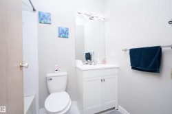 Contemporary bathroom with a white vanity, integrated sink, and chrome faucet - 