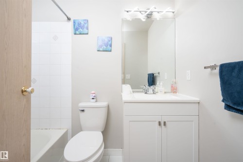 Bathroom with a white vanity featuring shaker-style cabinet doors and brushed nickel hardware - 108 2508 50 Street, Edmonton, AB 