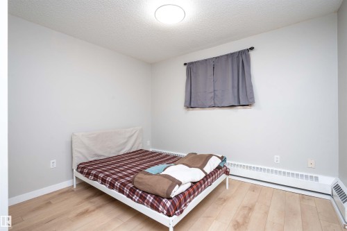 Room featuring light wood-finish flooring, light gray walls, and white baseboards - 108 2508 50 Street, Edmonton, AB 