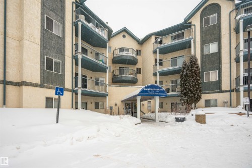 Multi-story building featuring stucco exterior, multiple balconies with railings, and a covered entrance - 108 2508 50 Street, Edmonton, AB 
