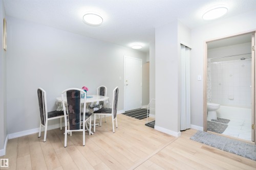 Light wood-finish flooring extending through living areas - 108 2508 50 Street, Edmonton, AB 