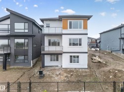 Contemporary multi-level exterior featuring white stucco and wood-finish siding accents - 