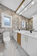 Dual vanity with integrated sinks, white cabinetry, and central wood-finish drawers - 