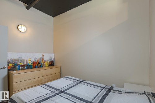 Cream-painted walls with exposed dark ceiling ductwork - 411 10024 Jasper Avenue, Edmonton, AB 