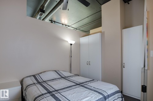 Exposed industrial-style ceiling with overhead ductwork and a ceiling fan - 411 10024 Jasper Avenue, Edmonton, AB 