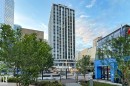 Modern high-rise building featuring a white and dark facade with a grid of windows - 411 10024 Jasper Avenue, Edmonton, AB 