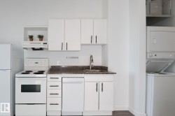 Kitchenette featuring white cabinetry, a white refrigerator, a white electric range, and a dishwasher - 