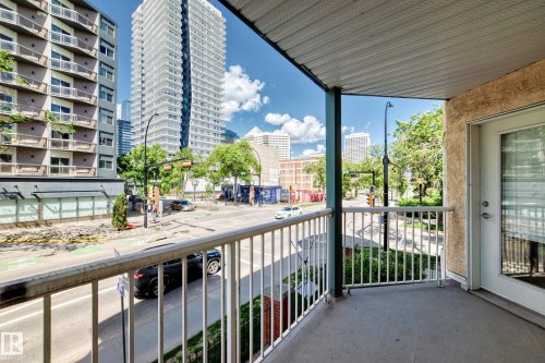 Private balcony with textured stucco exterior and a white aluminum railing - 214 9938 104 Street, Edmonton, AB 