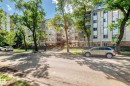 Multi-story residential building featuring a light-colored facade with contrasting vertical window sections - 214 9938 104 Street, Edmonton, AB 