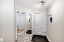 Entryway featuring a contemporary track light fixture, crisp white trim, and a mirrored sliding closet door - 