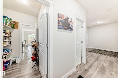 Hallway with light wood-finish flooring, white walls, and recessed lighting - 589 Boulder Wynd, Leduc, AB - Indoor Photo Showing Other Room