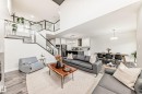 Expansive open-concept living area featuring high ceilings and wood-finish flooring - 589 Boulder Wynd, Leduc, AB  - Indoor Photo Showing Living Room 
