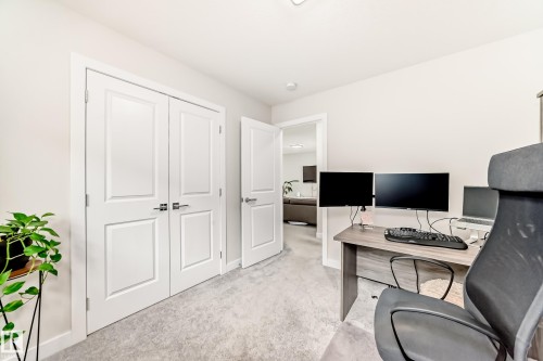 Neutral-toned room featuring light gray carpet flooring and white trim - 589 Boulder Wynd, Leduc, AB - Indoor Photo Showing Office