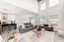 Spacious living area featuring a vaulted ceiling and multiple large windows - 589 Boulder Wynd, Leduc, AB  - Indoor Photo Showing Living Room 
