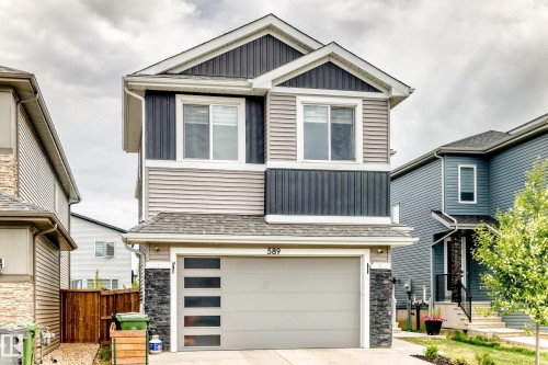 Two-story residence featuring a combination of horizontal siding, vertical board and batten siding, and stone accents - 589 Boulder Wynd, Leduc, AB - Outdoor