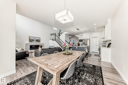 Open-concept living space featuring wood-finish flooring - 589 Boulder Wynd, Leduc, AB - Indoor Photo Showing Dining Room
