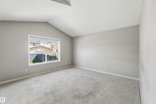 Spacious room featuring vaulted ceilings and a large window - 2012 35A Avenue, Edmonton, AB 
