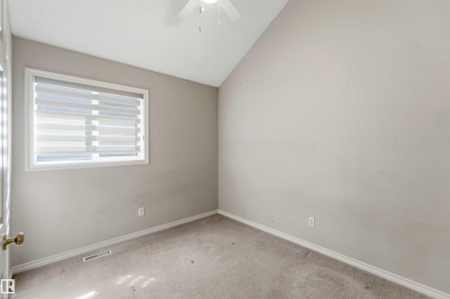 Room featuring light gray wall paint, carpeting, a white window frame with horizontal blinds, white baseboards, and a white ceiling fan - 2012 35A Avenue, Edmonton, AB 