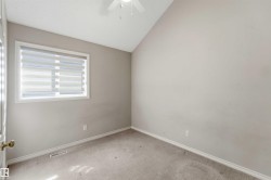 Room featuring light gray wall paint, carpeting, a white window frame with horizontal blinds, white baseboards, and a white ceiling fan - 