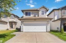 Front exterior featuring a two-car garage, light-colored siding, and a concrete driveway - 2012 35A Avenue, Edmonton, AB 