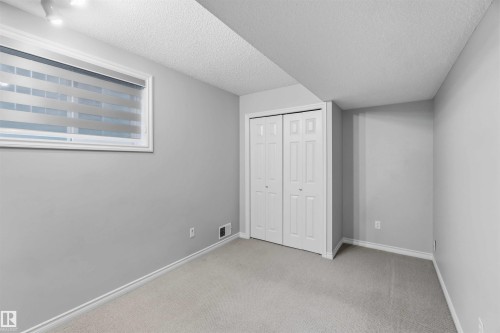 Carpeted room with light gray walls and white trim - 2012 35A Avenue, Edmonton, AB 