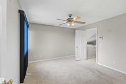 Carpeted room with a ceiling fan light fixture - 