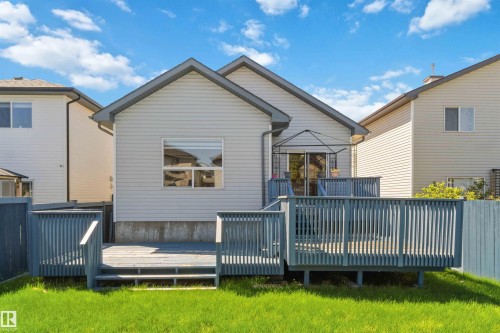 Expansive multi-level wood deck featuring a protective railing and direct access to the interior via sliding glass doors - 2012 35A Avenue, Edmonton, AB 