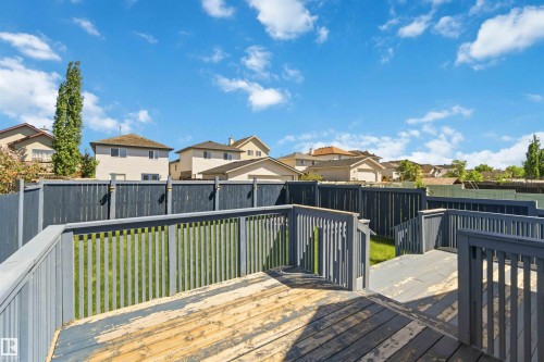 Multi-level deck with wood railing, offering defined outdoor spaces - 2012 35A Avenue, Edmonton, AB 