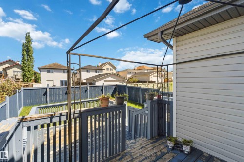 Multi-level wooden deck with dark gray railings and an open metal pergola structure - 2012 35A Avenue, Edmonton, AB 