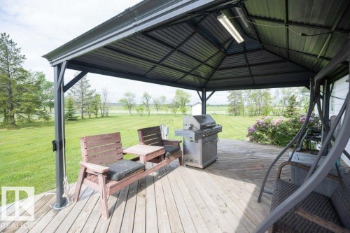 Spacious outdoor deck featuring a dark-toned metal gazebo with integrated lighting - 57532 Rg Rd 270, Rural Westlock County, AB 