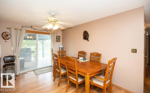 Dining area featuring wood-finish flooring and a ceiling fan with integrated lighting - 57532 Rg Rd 270, Rural Westlock County, AB 