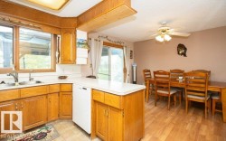Kitchen with wood-finish cabinetry and a white countertop - 