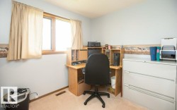 Carpeted room featuring a light wall color, wood-trimmed window, and a textured ceiling - 